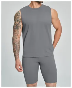 Detailed view of grey men's sleeveless athletic tank top and shorts set on model