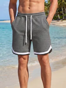 Men's grey waffle texture athletic shorts with white drawstring and contrast hem trim