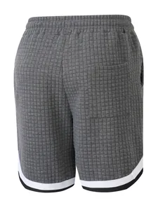 Detailed back view of gray waffle-textured men's athletic shorts featuring striped hem