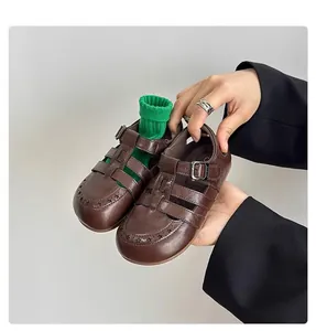 Detailed view of vintage dark brown hollow Roman leather sandals for boys and girls