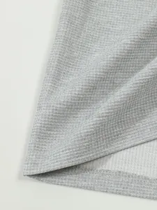 Macro view of high-quality grey waffle knit fabric texture for men's vintage shirt