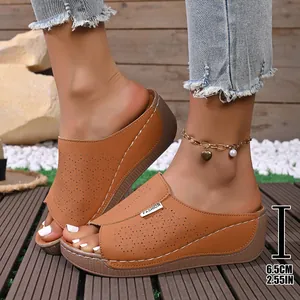 Close-up detail of women's laser-cut wedge sandals featuring a 6.5cm height heel