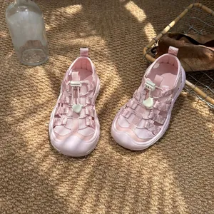 Detailed close-up view of pink breathable mesh kids closed-toe sandals for summer beach
