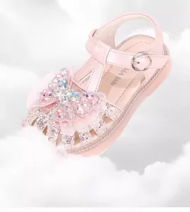 Detail view of pink girl's princess sandal with sparkling rhinestone butterfly