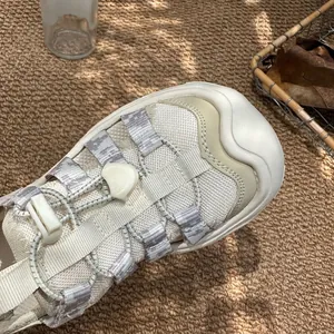 Close-up of breathable mesh fabric and protective closed-toe on kids sandals