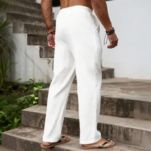 Back view of men's breathable white linen pants in a loose casual straight fit.