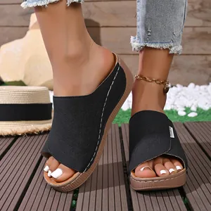 Comfortable women's black platform wedge sandals with intricate laser-cut floral patterns