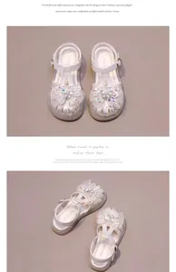 Close-up detail of girls' white sandals with glittering rhinestone butterfly