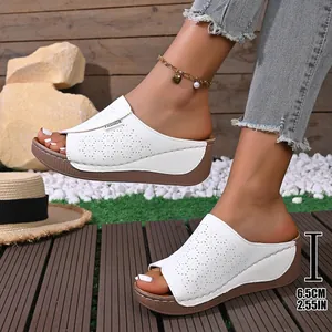Stylish white women's wedge sandals featuring laser-cut floral patterns and 6.5cm platform