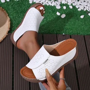 Detailed view of white laser-cut hollow-out wedge slippers for women summer