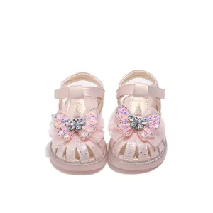 Pink girls sandals with crystal butterfly ornament and glittery closed-toe design