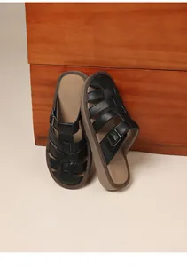 Stylish retro black soft-sole slides featuring buckle detail and textured leather straps