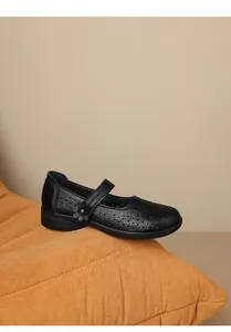 Detailed view of black breathable mama shoes with floral hollow patterns and decorative flower.