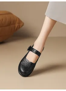 Detailed macro view of black breathable hollow-out leather Mary Jane shoes for elderly women
