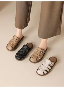 Detailed view of vintage woven flat slide sandals for women in black beige and white