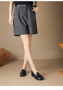 Detailed side view of comfortable black soft leather loafers worn with casual gray shorts