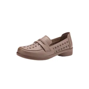 Women's brown soft leather loafers with hollow-out pattern and flat comfortable sole.