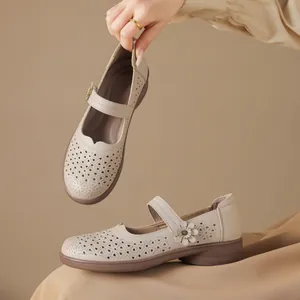 Vintage beige Mary Jane flats with breathable laser-cut patterns for comfort.
