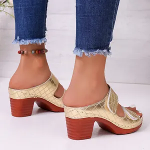 Elegant gold quilted peep-toe mules with a stylish chunky wood-style platform heel.