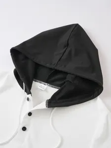 Detail of men's waffle knit short sleeve hoodie with black hood and button placket