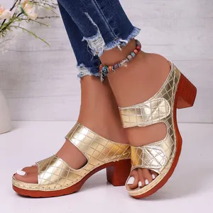 Elegant gold open-toe mules with embossed quilted pattern and chunky wooden block heels