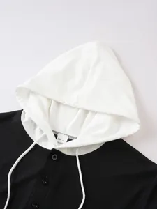 Close-up of hooded waffle knit shirt with white drawstring and button detail