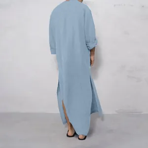 Rear view of a light blue long-sleeved kaftan for men showing elegant side slits and fabric drape