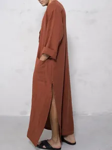 Side profile of a loose-fit rust-colored traditional long robe with side slit and pocket