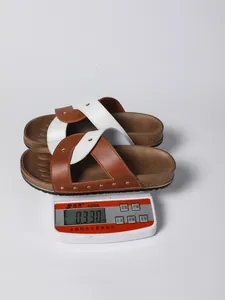 Detailed view of studded crisscross sandals on an electronic scale weighing 0.330kg