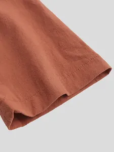 Close-up detail of the high-quality textured cotton fabric and durable hem stitching on a vintage robe.