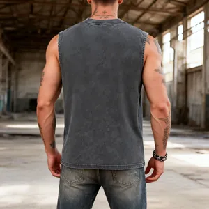 Back view of a men's vintage washed heavy cotton sleeveless tank top in industrial background
