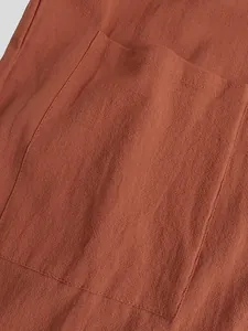 Close-up of a patch pocket on a men's terracotta linen-textured retro robe