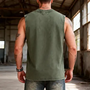 Back view of a vintage washed olive green heavy cotton tank top for men in industrial setting
