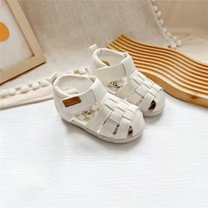 Closed-toe cream white leather sandals for toddlers with woven detail and Velcro strap