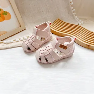 Detailed view of pink closed-toe children leather sandals with easy velcro straps