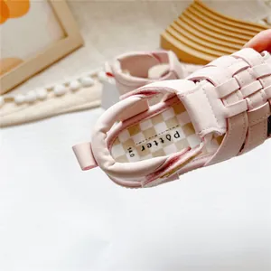 Macro detail of pink children's sandals showing soft insole with brand logo Potter