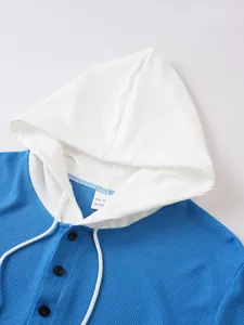 Close-up of men's blue and white waffle knit short sleeve hoodie with buttons