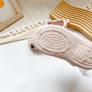 Detailed view of the non-slip star patterned pink sole on a baby closed-toe sandal
