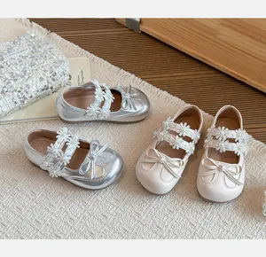 Detailed view of girls' princess shoes with floral lace straps and bows