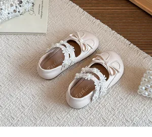 Detailed view of beige girls princess shoes with delicate lace flowers and pearl accents
