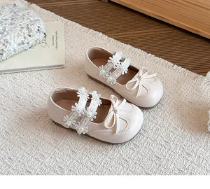 Close-up of pink toddler princess shoes featuring daisy flower lace and pearl details