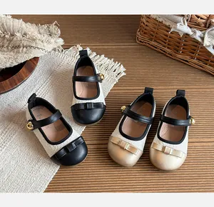 Detailed view of Chanel-style girls' princess shoes in black and gold variants
