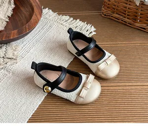 Elegant girl's tweed princess shoes with a golden bow detail and black strap