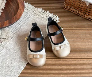 Close-up of elegant tweed Mary Jane shoes for girls with golden bow details and straps