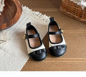 Elegant tweed children's Mary Jane shoes with bow detail and gold button finish.
