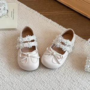 Elegant cream girls princess shoes featuring delicate lace flowers and bow details