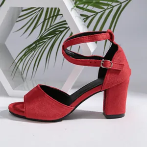 Side profile of red suede block heel sandals with ankle strap and peep toe detail