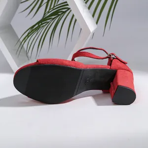 Detail showing the durable anti-slip sole of the red block heel sandals.