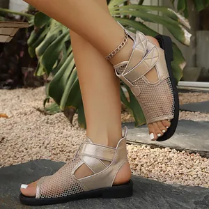 Detailed view of women's gold mesh hollow-out flat sandals with comfortable straps