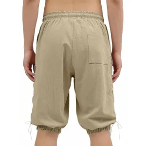 Back view detail of men's loose khaki linen 3/4 pants featuring side lace-up hem design